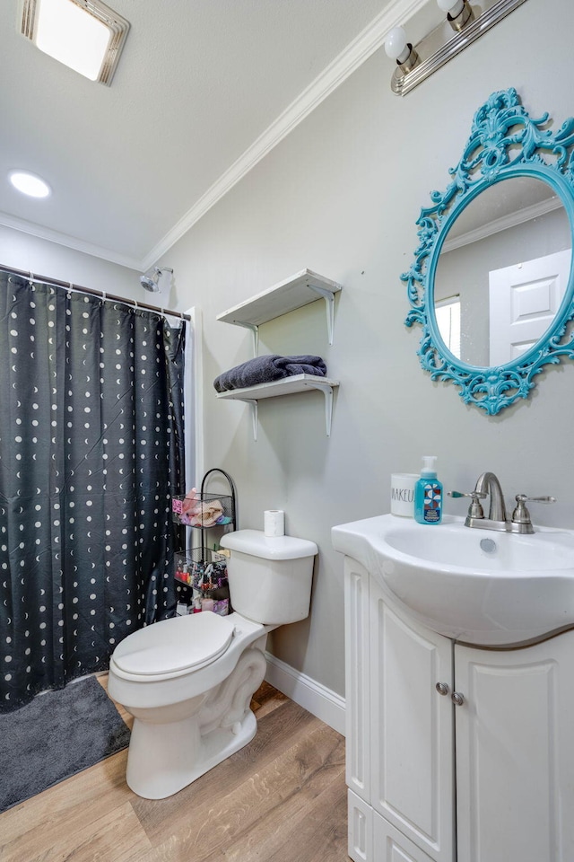 bathroom featuring toilet, crown molding, vanity, wood-type flooring, and a shower with shower curtain