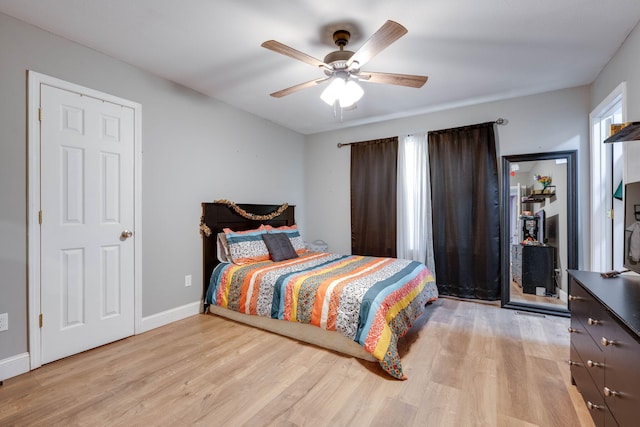 bedroom with light hardwood / wood-style flooring and ceiling fan