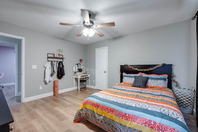 bedroom with light hardwood / wood-style flooring and ceiling fan