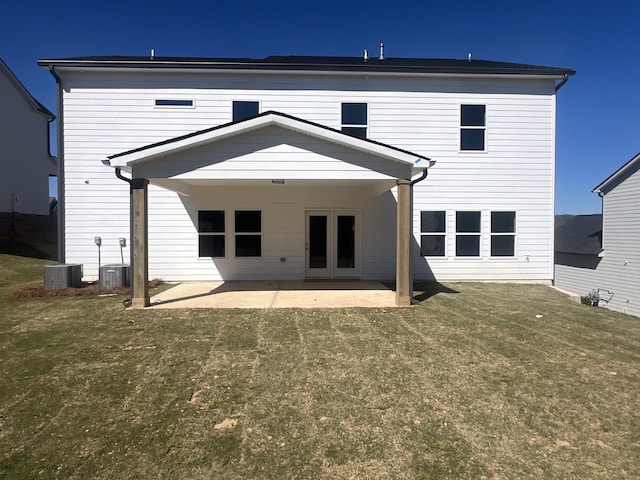 back of house featuring a yard, a patio area, and central AC unit