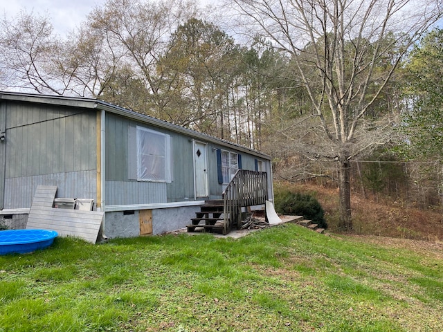 view of side of home featuring a yard