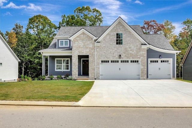 view of front of property featuring a garage and a front lawn