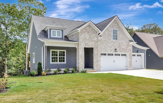 view of front facade featuring cooling unit, a garage, and a front lawn