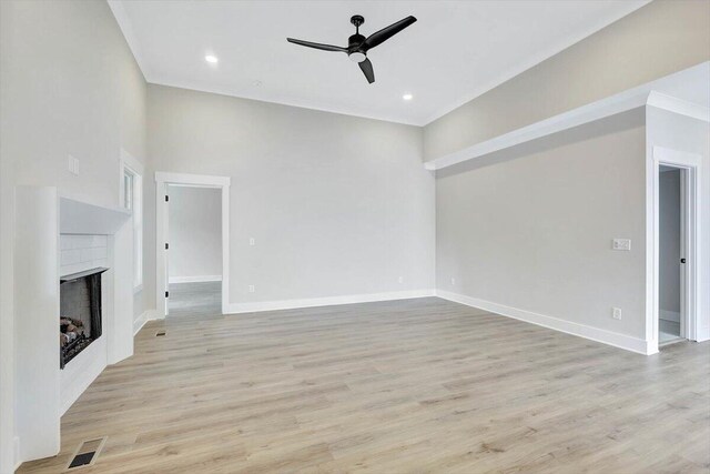 unfurnished living room with light wood-type flooring and ceiling fan