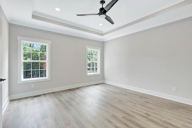 unfurnished room with light wood-type flooring, plenty of natural light, and ceiling fan