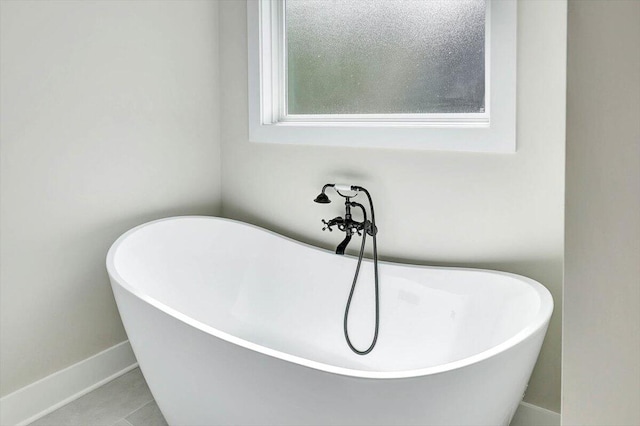 room details with a bathtub and tile patterned floors