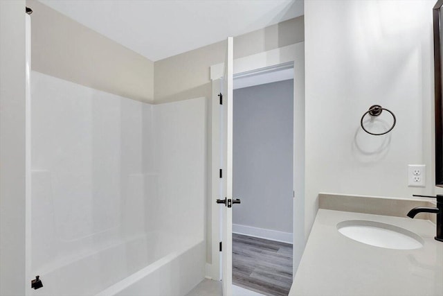 bathroom with vanity, shower / bathtub combination, and hardwood / wood-style flooring