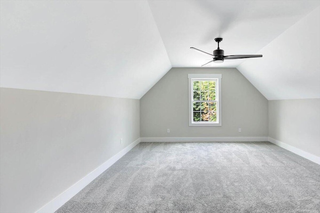 additional living space featuring ceiling fan, light carpet, and vaulted ceiling