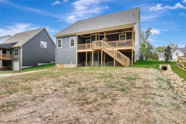 rear view of house featuring a lawn and ceiling fan