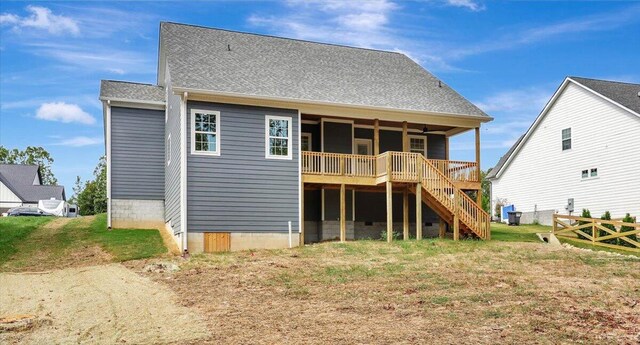 rear view of property with a lawn and a wooden deck