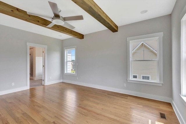 spare room with ceiling fan, light hardwood / wood-style floors, and beam ceiling