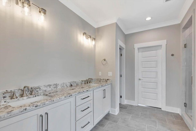 bathroom featuring crown molding, vanity, tile patterned flooring, and a shower with door