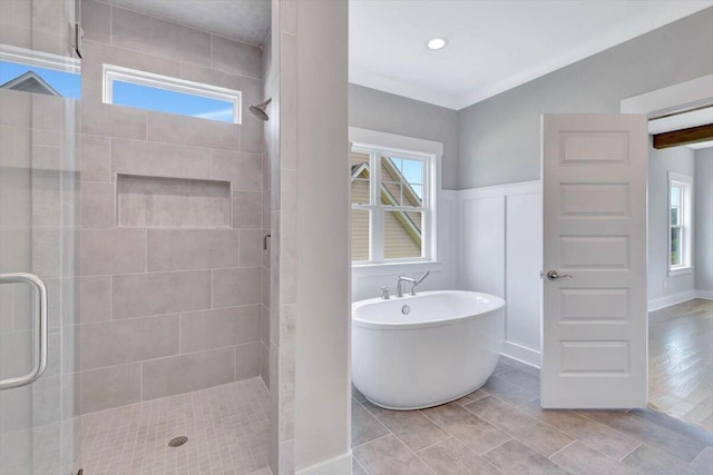 bathroom featuring hardwood / wood-style flooring and plus walk in shower