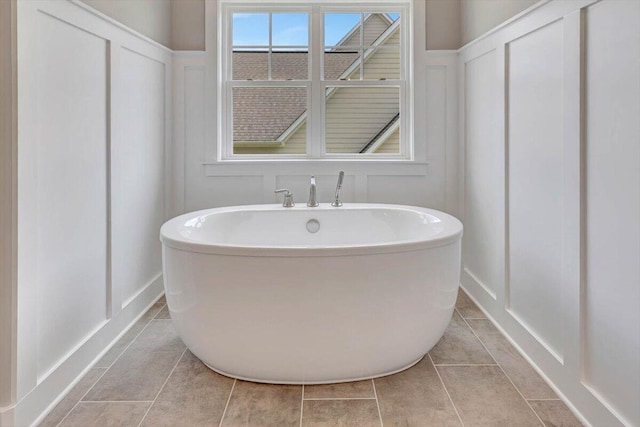 bathroom featuring a tub to relax in and tile patterned floors