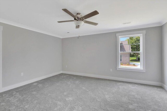 carpeted spare room featuring ceiling fan and ornamental molding