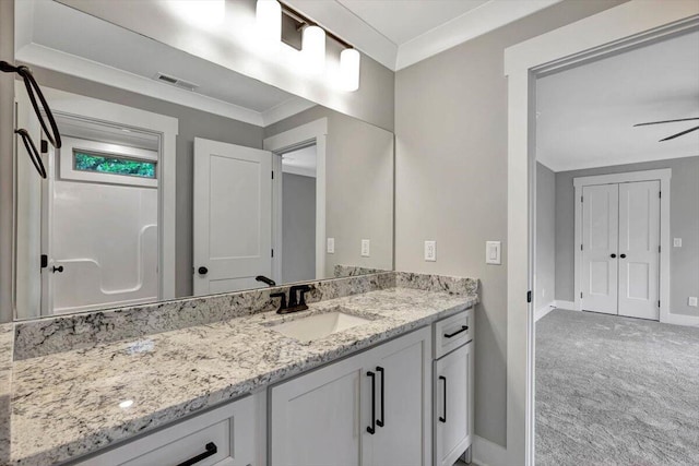 bathroom with vanity, ceiling fan, and ornamental molding