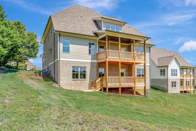 back of house featuring a yard, central AC, and a balcony