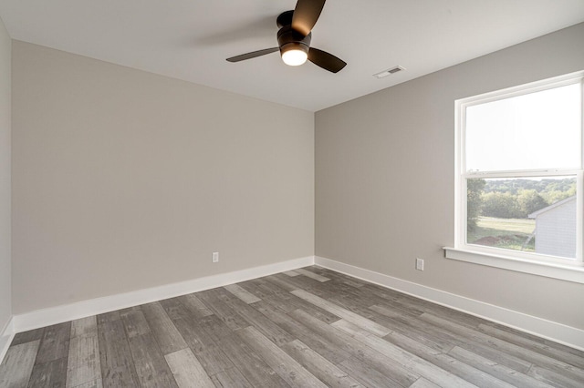 empty room featuring wood-type flooring and ceiling fan