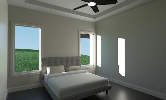 bedroom featuring a raised ceiling and ceiling fan