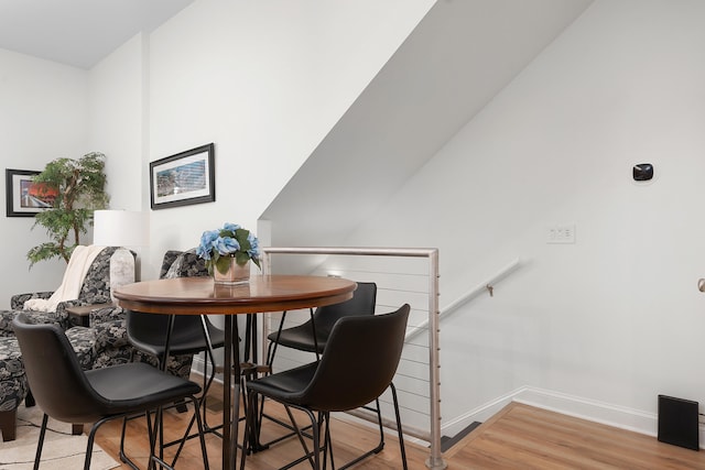 dining space with hardwood / wood-style floors