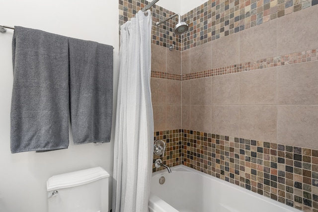 bathroom with toilet and shower / tub combo with curtain