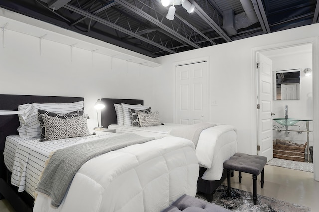 bedroom with ceiling fan, a closet, and concrete flooring