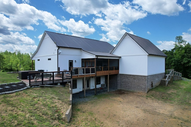 1033 SE Carter Rd, Old Fort, TN 37362 - back of property featuring a lawn, metal roof, a sunroom, and a deck