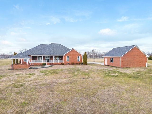 back of property featuring a porch and a yard