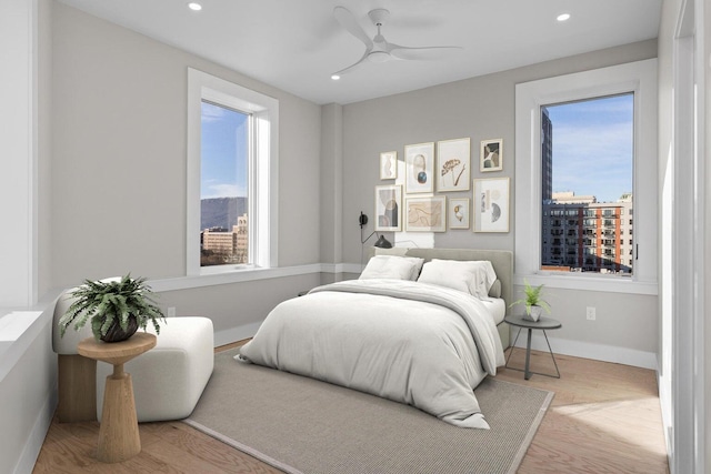 bedroom with light hardwood / wood-style flooring and ceiling fan