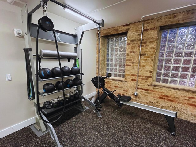 exercise area featuring brick wall