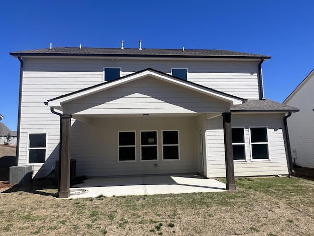 rear view of house featuring a yard, cooling unit, and a patio area