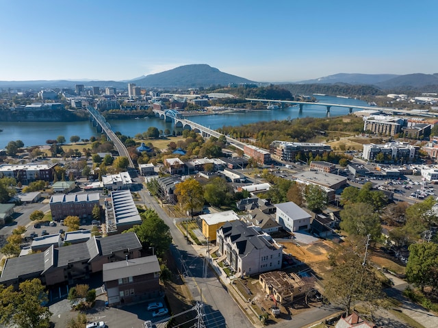 drone / aerial view featuring a water and mountain view