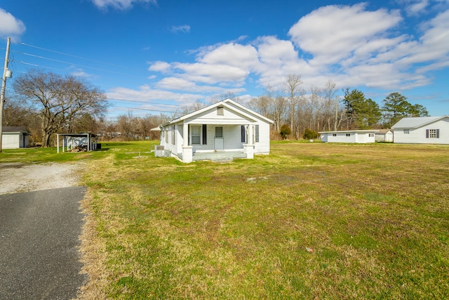 exterior space with an outdoor structure, covered porch, and a garage