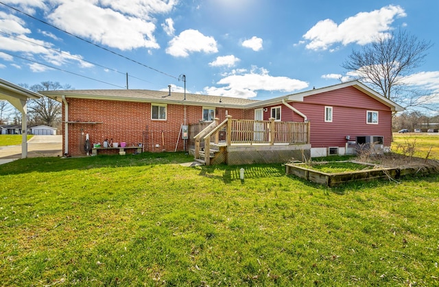 2237 Cloud Springs Rd, Rossville, GA 30741 - rear view of house featuring a wooden deck, a vegetable garden, brick siding, and a yard