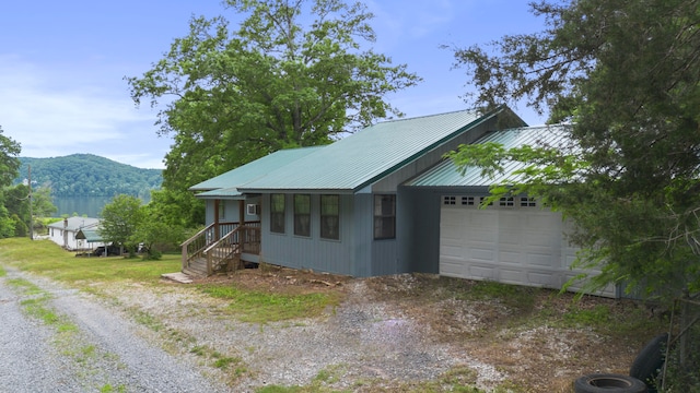 view of side of home with a mountain view and a garage