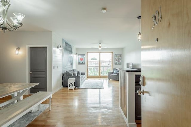 hallway with light hardwood / wood-style flooring