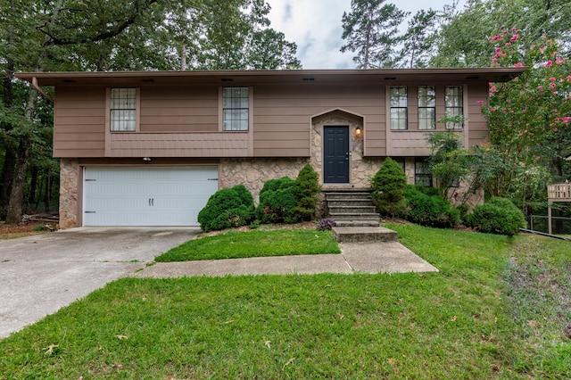 bi-level home with a garage and a front yard