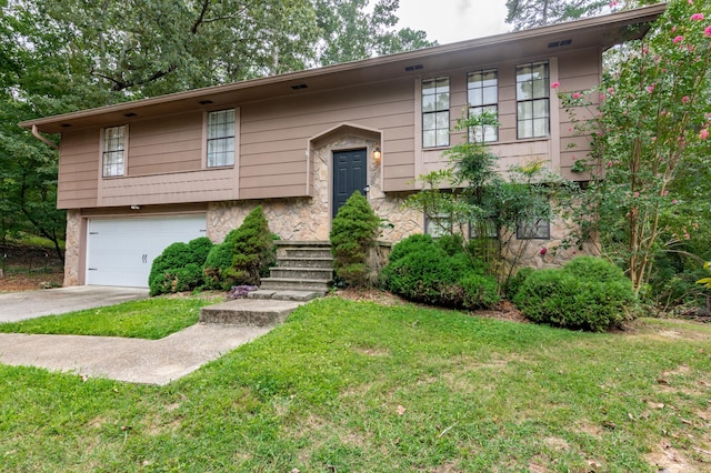 split foyer home with a front yard and a garage