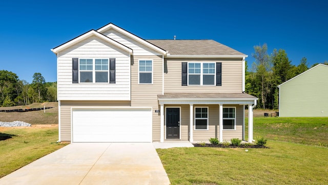 view of front of property with a garage and a front lawn