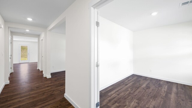 corridor with dark hardwood / wood-style floors