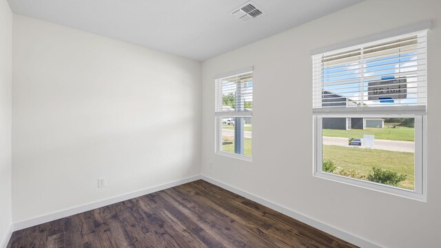 empty room with dark hardwood / wood-style floors