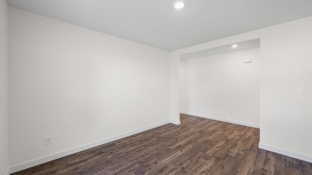 spare room with dark wood-type flooring