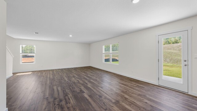 unfurnished room with dark hardwood / wood-style floors and a wealth of natural light