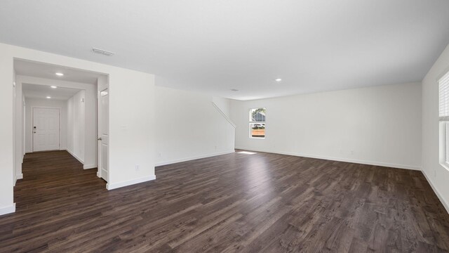 unfurnished living room with dark wood-type flooring