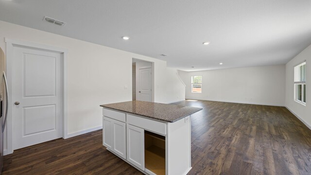 kitchen featuring a center island, white cabinetry, dark hardwood / wood-style flooring, and a wealth of natural light