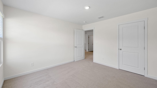 unfurnished bedroom with light carpet