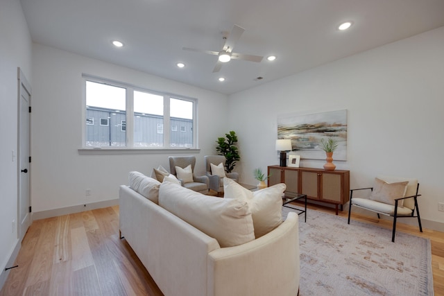 living room featuring light wood-type flooring and ceiling fan