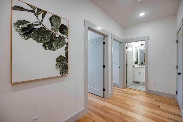 hall with light hardwood / wood-style flooring