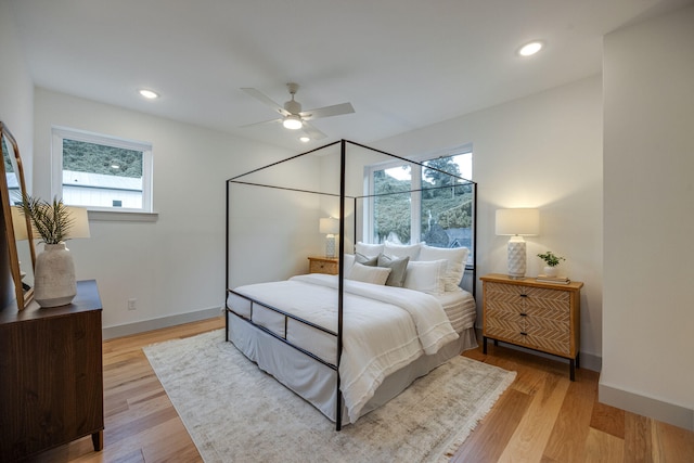 bedroom with light hardwood / wood-style flooring and ceiling fan