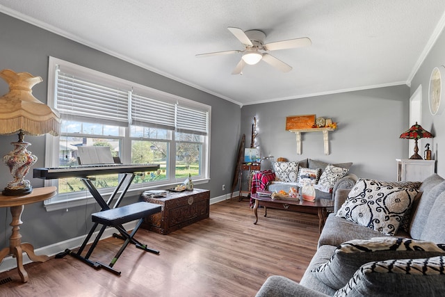 living room with hardwood / wood-style flooring, ceiling fan, ornamental molding, and a wealth of natural light